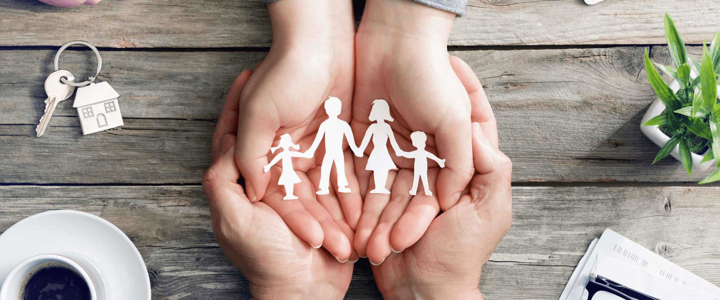 Hands holding a papercut out of a family of 4