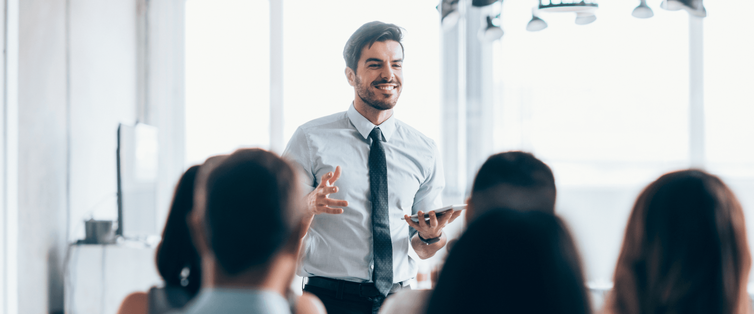 A finance manager talking to his team in a meeting