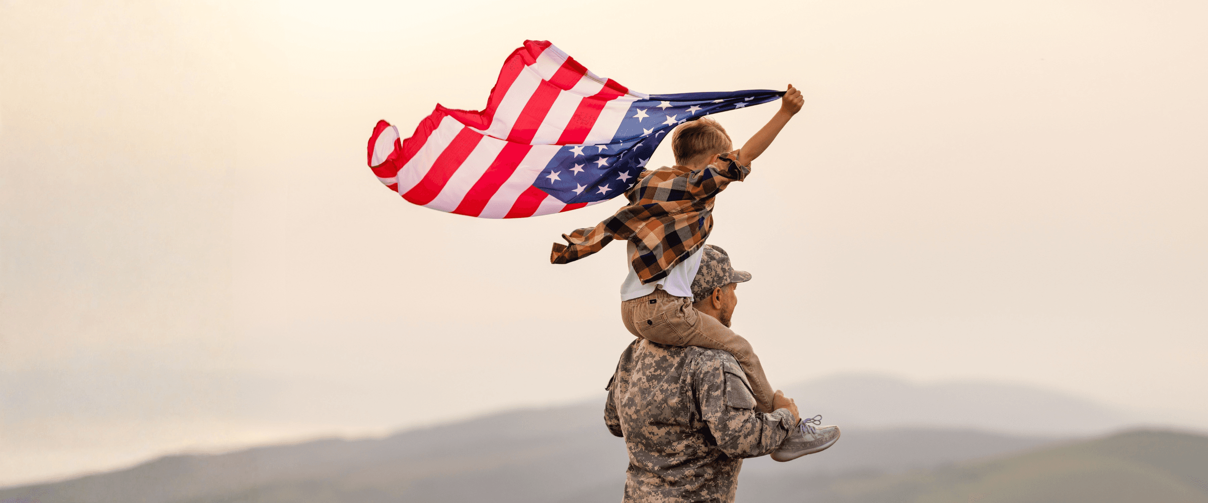 Veteran playing with young son outside.